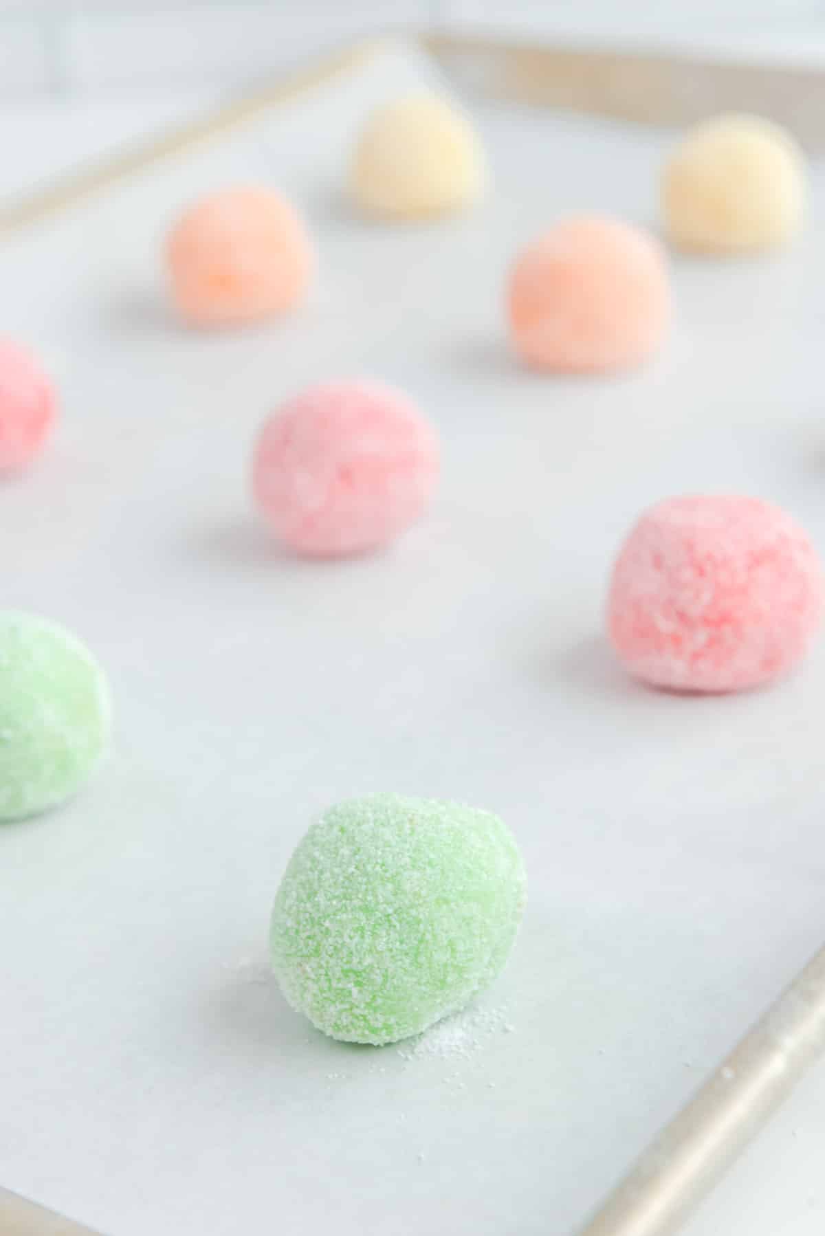 round balls with sugar on baking sheet