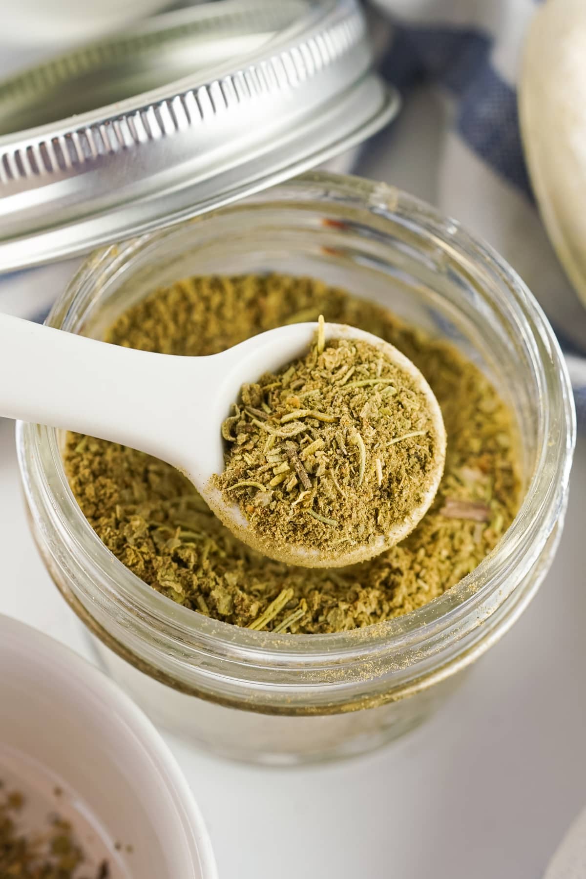 A spoonful of Poultry Seasoning in a jar.