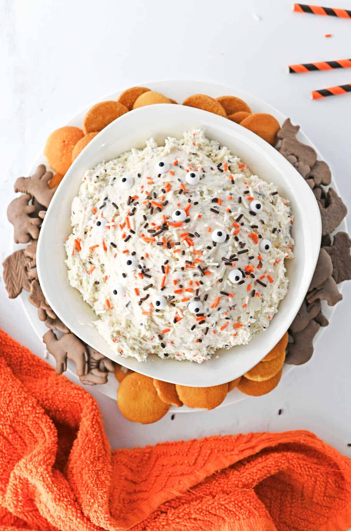 A bowl of halloween dip with cookies and crackers.