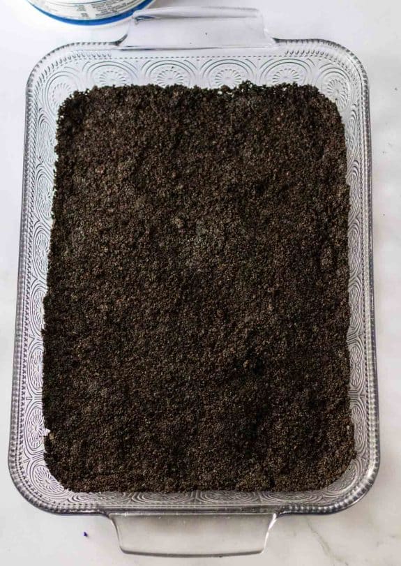 A glass baking dish filled with Oreo crumbles.