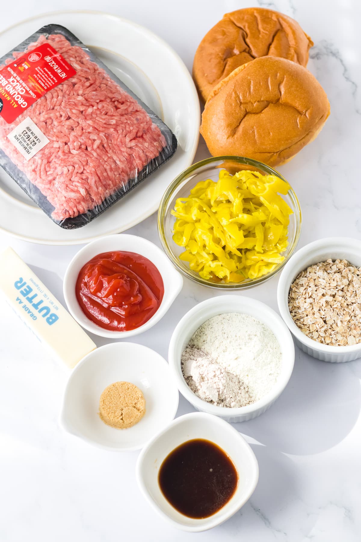 The ingredients for Slow Cooker Mississippi Sloppy Joes are the following: Lean ground beef, Ranch dressing mix, Brown gravy mix, Sliced pepperoncini peppers, Quick cooking oatmeal, Ketchup, Water, Pepperoncini juice, Worcestershire sauce, Brown sugar, Butter and Sandwich buns