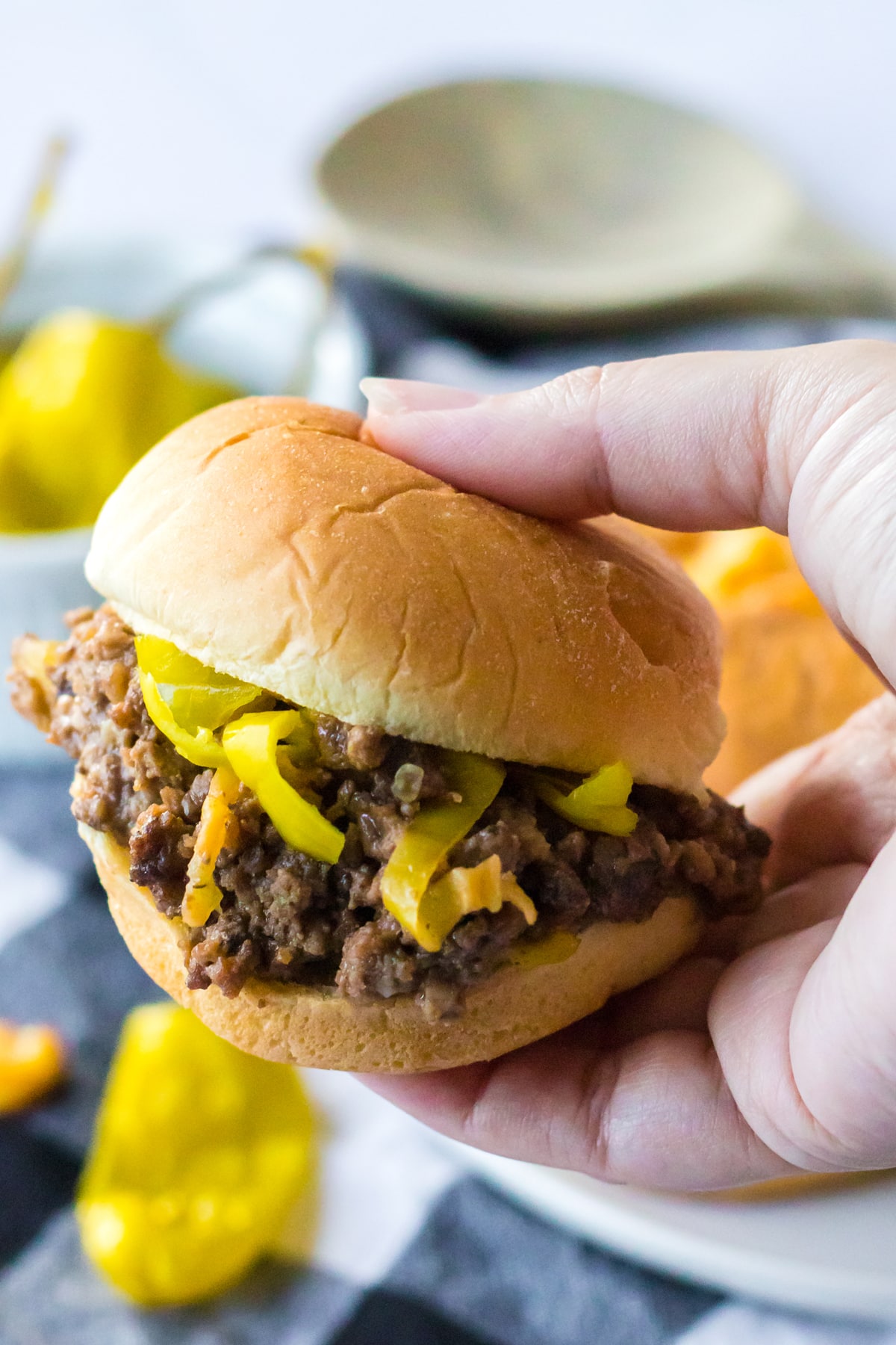 A hand holding a Slow Cooker Mississippi Sloppy Joe