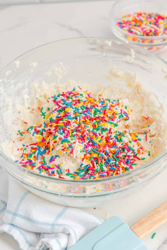 A glass bowl with sprinkles in it.