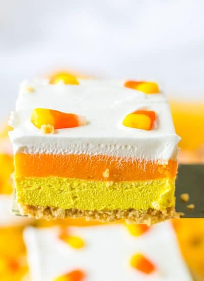 A piece of candy corn layered cake on a fork.