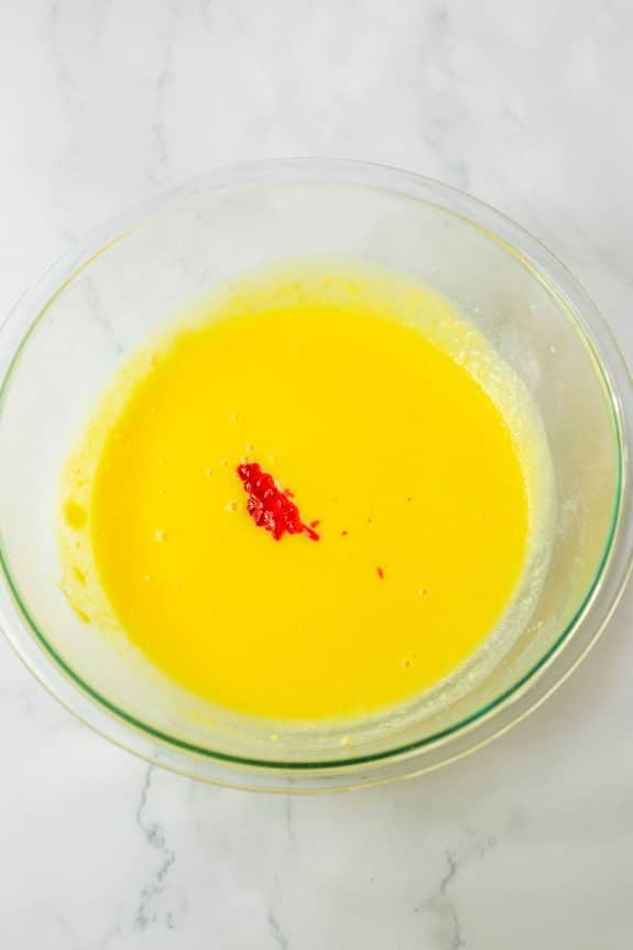 A glass bowl filled with yellow liquid.