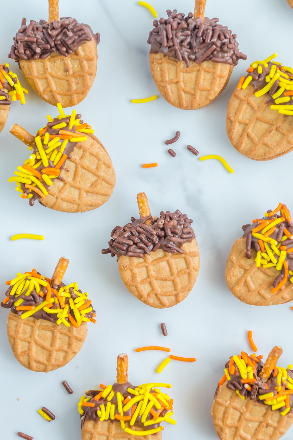 A group of Nutter Butter Acorns decorated with sprinkles and icing.