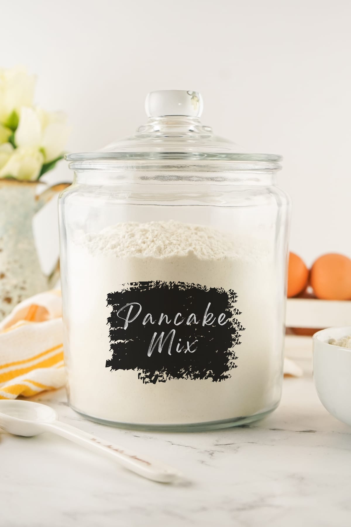 A glass jar of Homemade Pancake Mix with label
