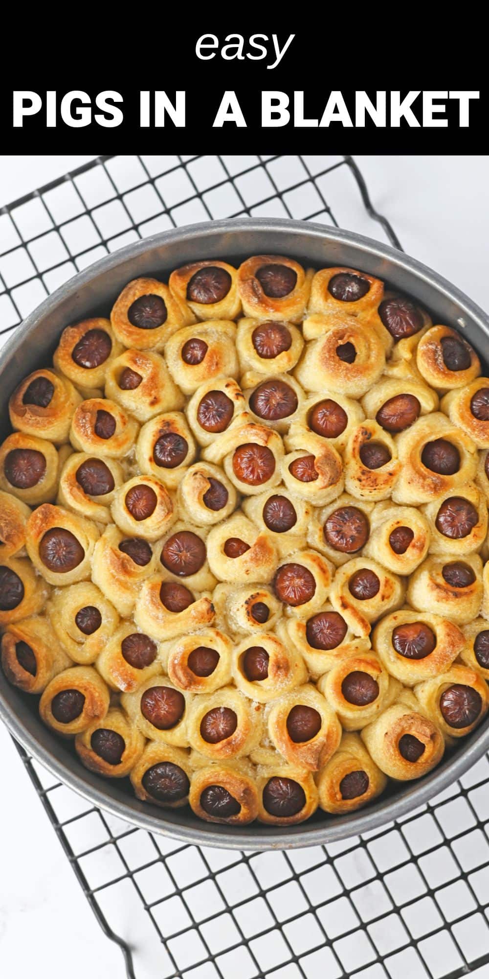 These easy pull apart Pigs in a Blanket are a delicious and fun twist on the classic party appetizer. Instead of crescent roll dough, these tasty bites are wrapped in pizza dough and baked to golden brown perfection in a spring-form pan.  
