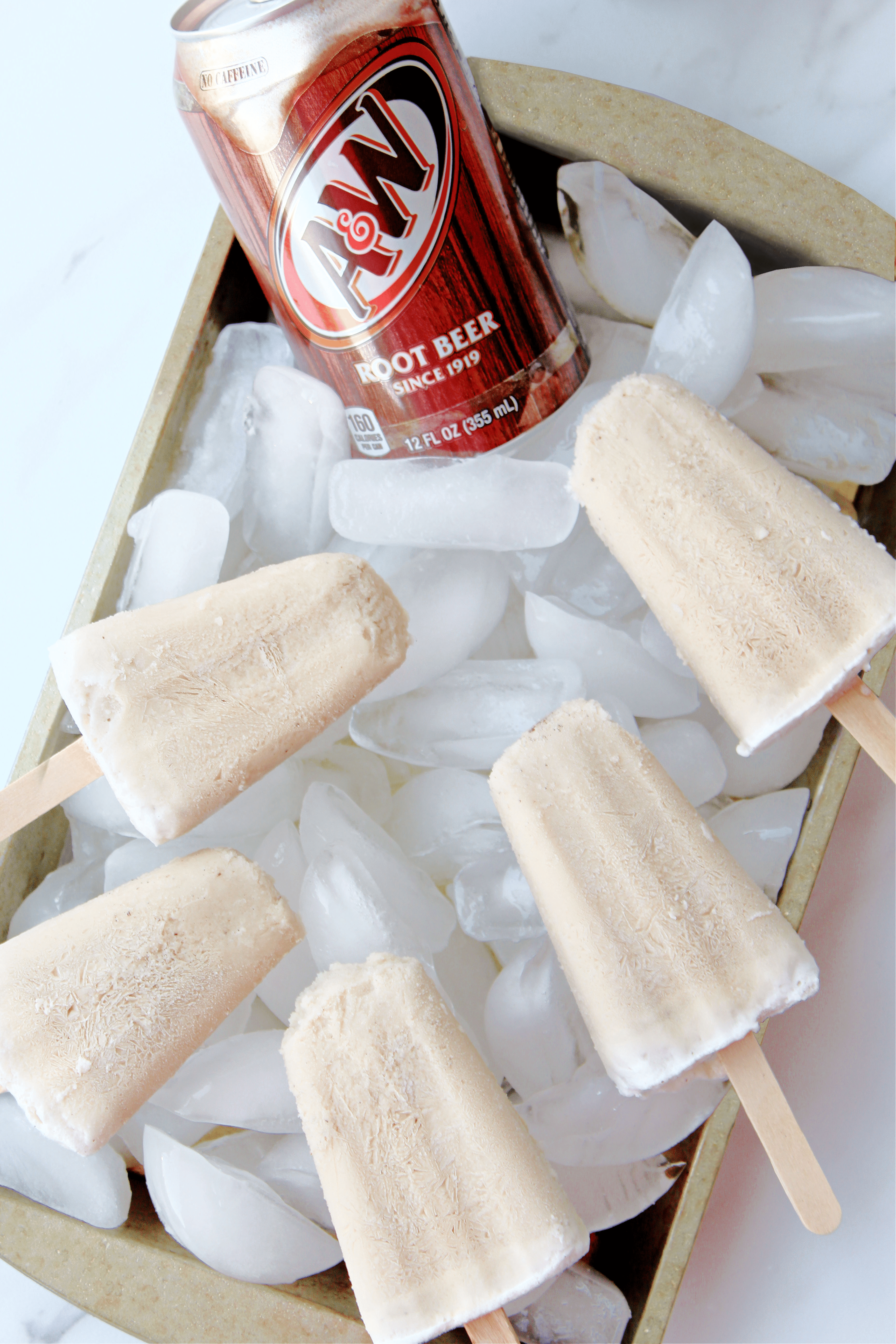 root beer popsicles on baking sheet lined with ice