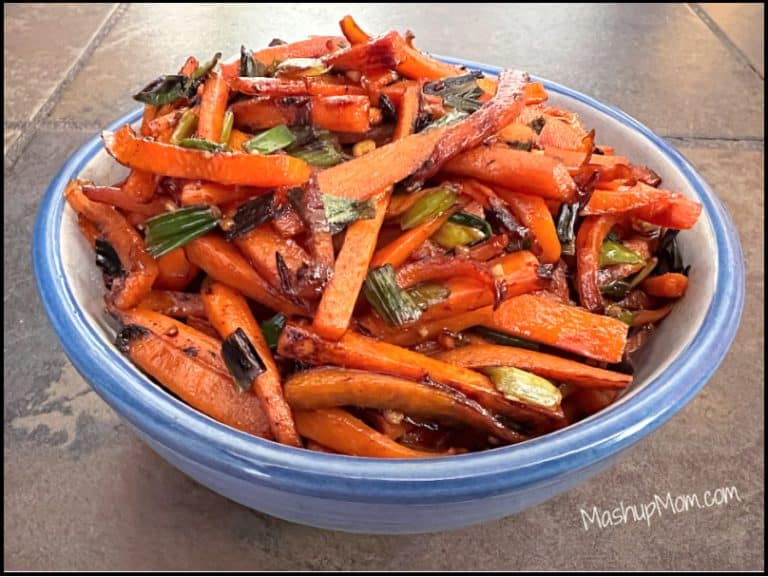 Carrots in a blue bowl on a table.