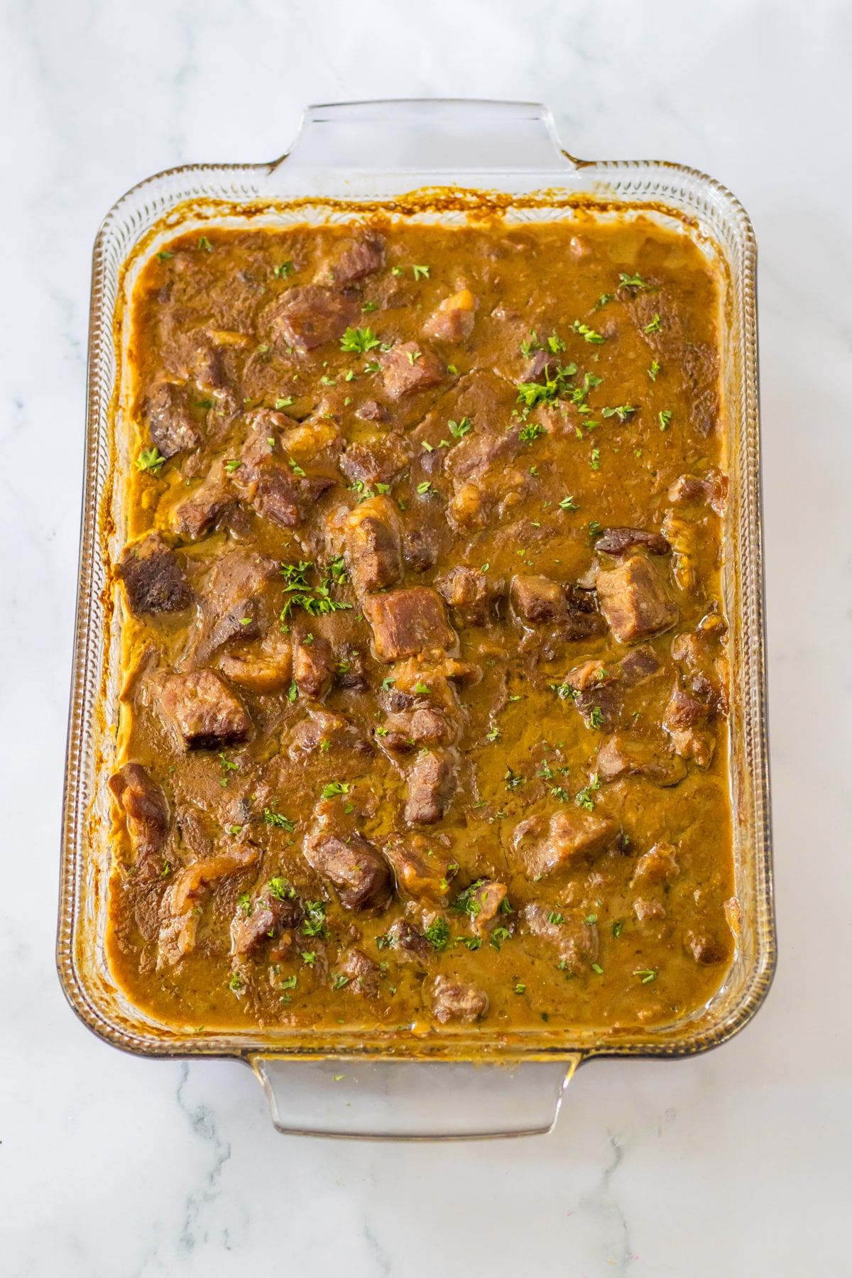 A tray of Beef Tips with vegetable toppings