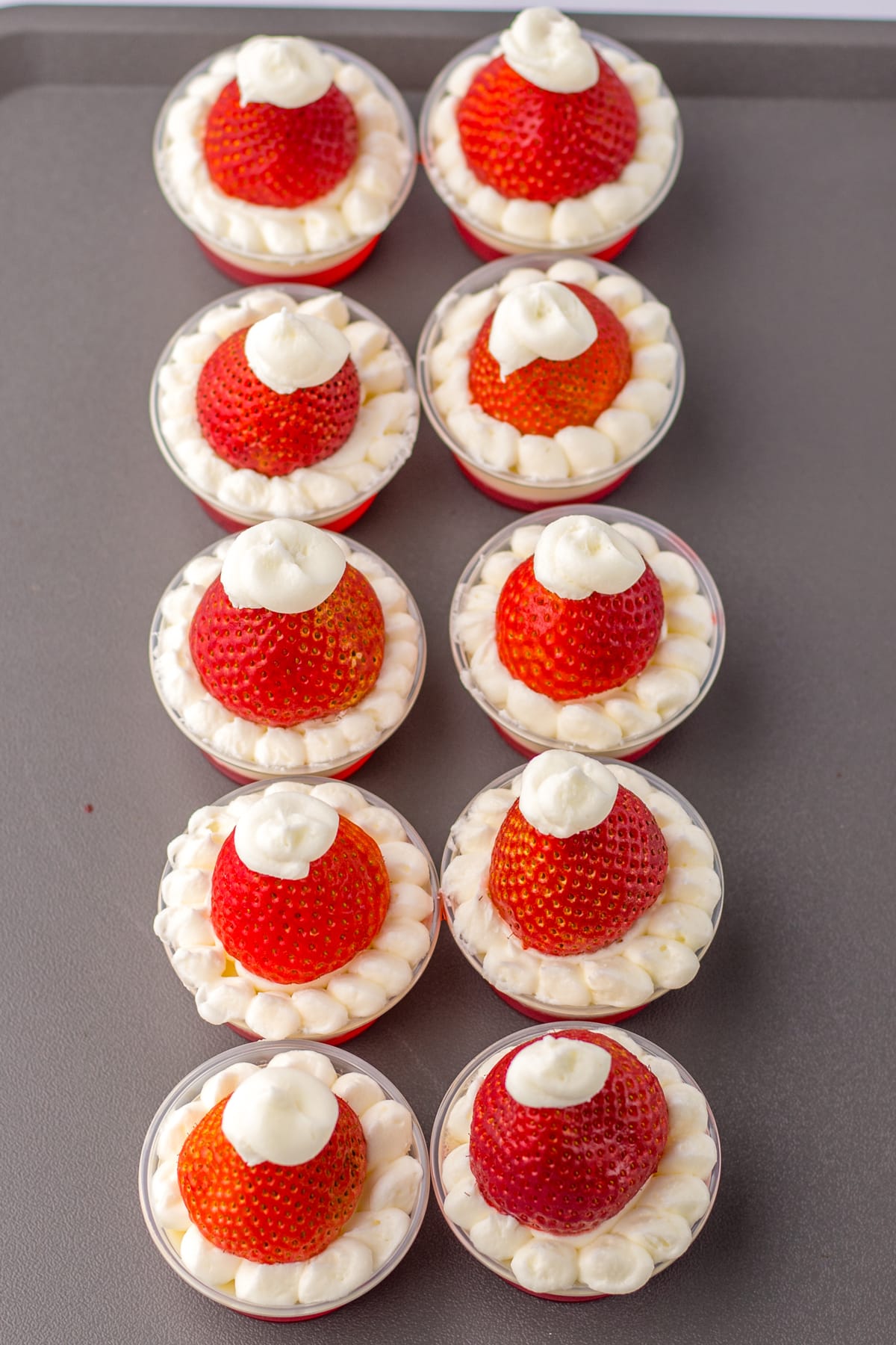 The last step in Santa Hat Jello Shots is to add strawberries to it.