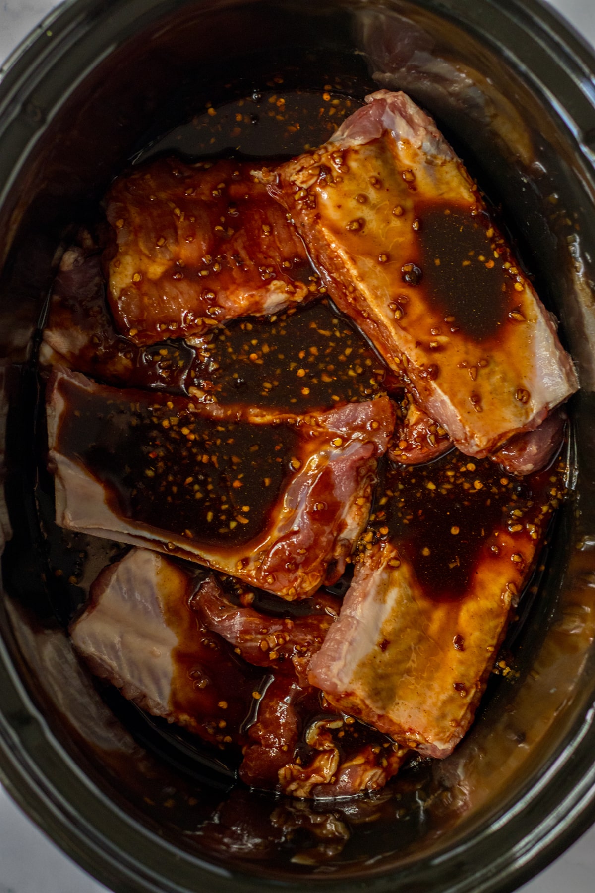 Next process in preparing Slow Cooker Spare Ribs is to add the mixture to the ribs.