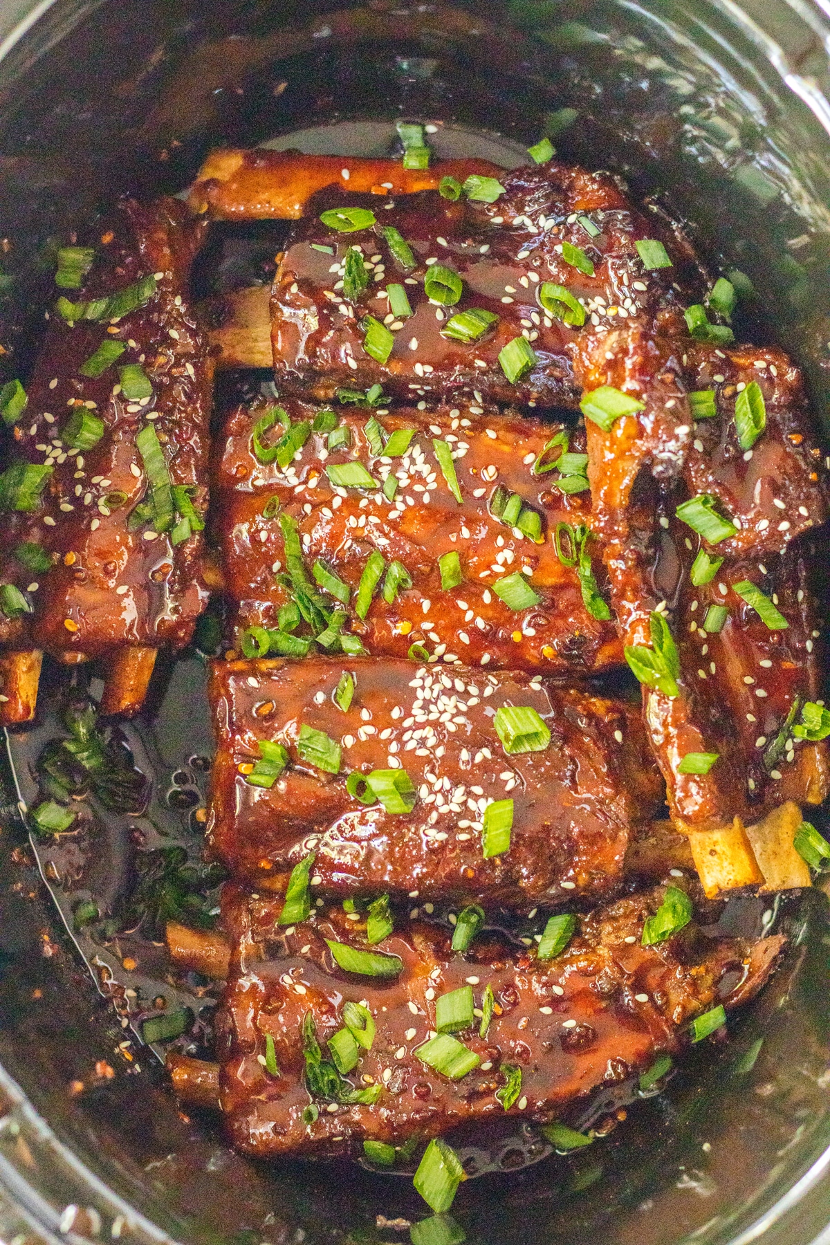 Slow Cooker Spare Ribs with sauce and green onions.