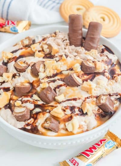 A bowl of ice cream with chocolate and peanut butter.