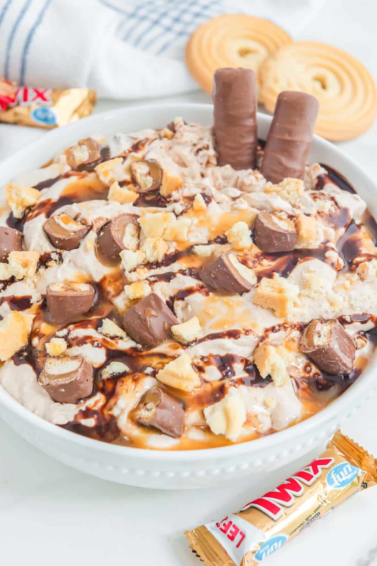 A bowl of ice cream with chocolate and peanut butter.