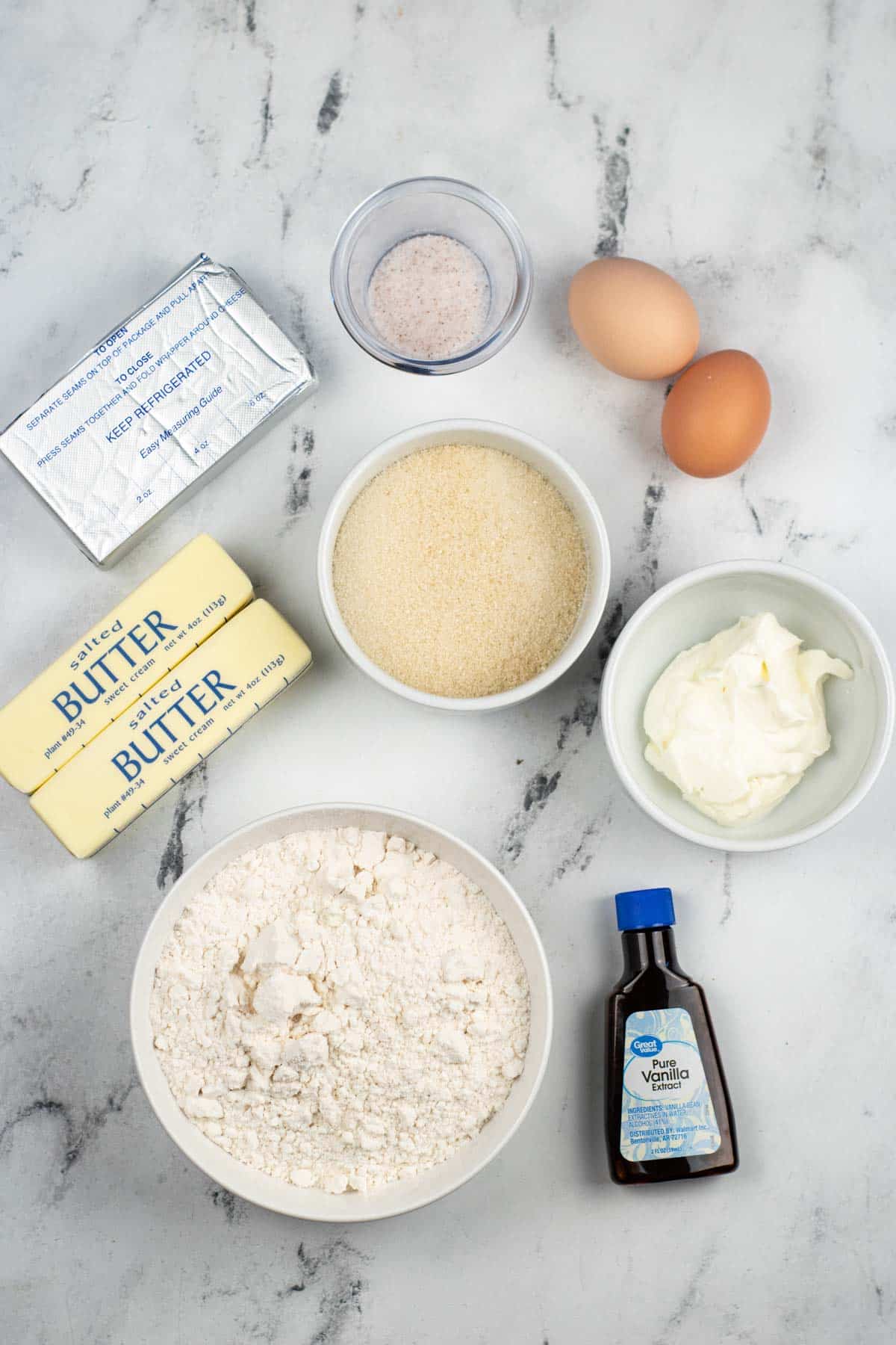 The ingredients for a recipe for buttermilk pancakes are shown on a marble table.