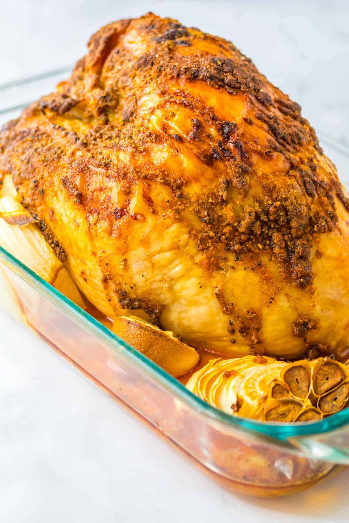 Roasted turkey in a glass baking dish.