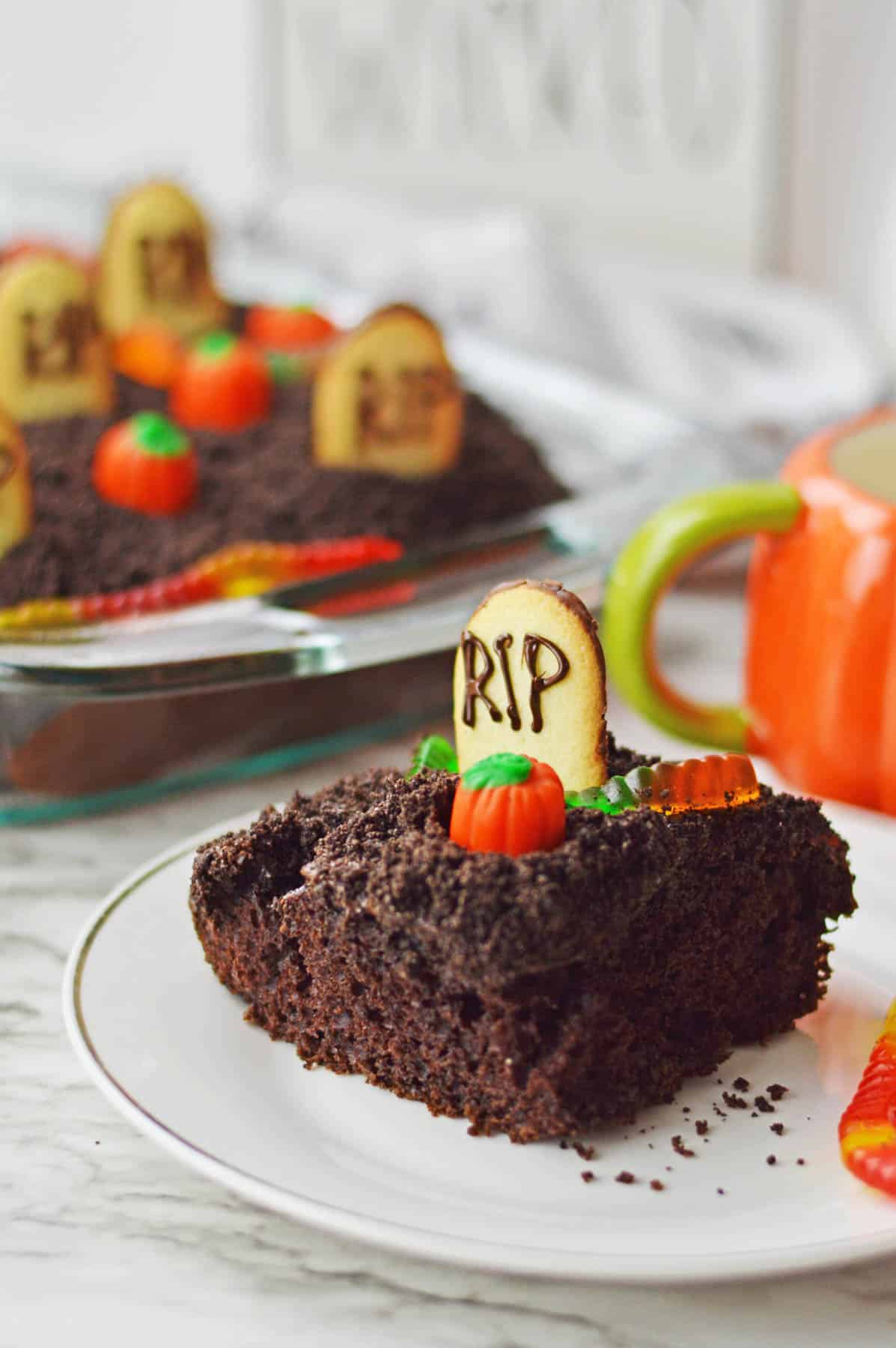 A plate of chocolate cake with pumpkins on it.