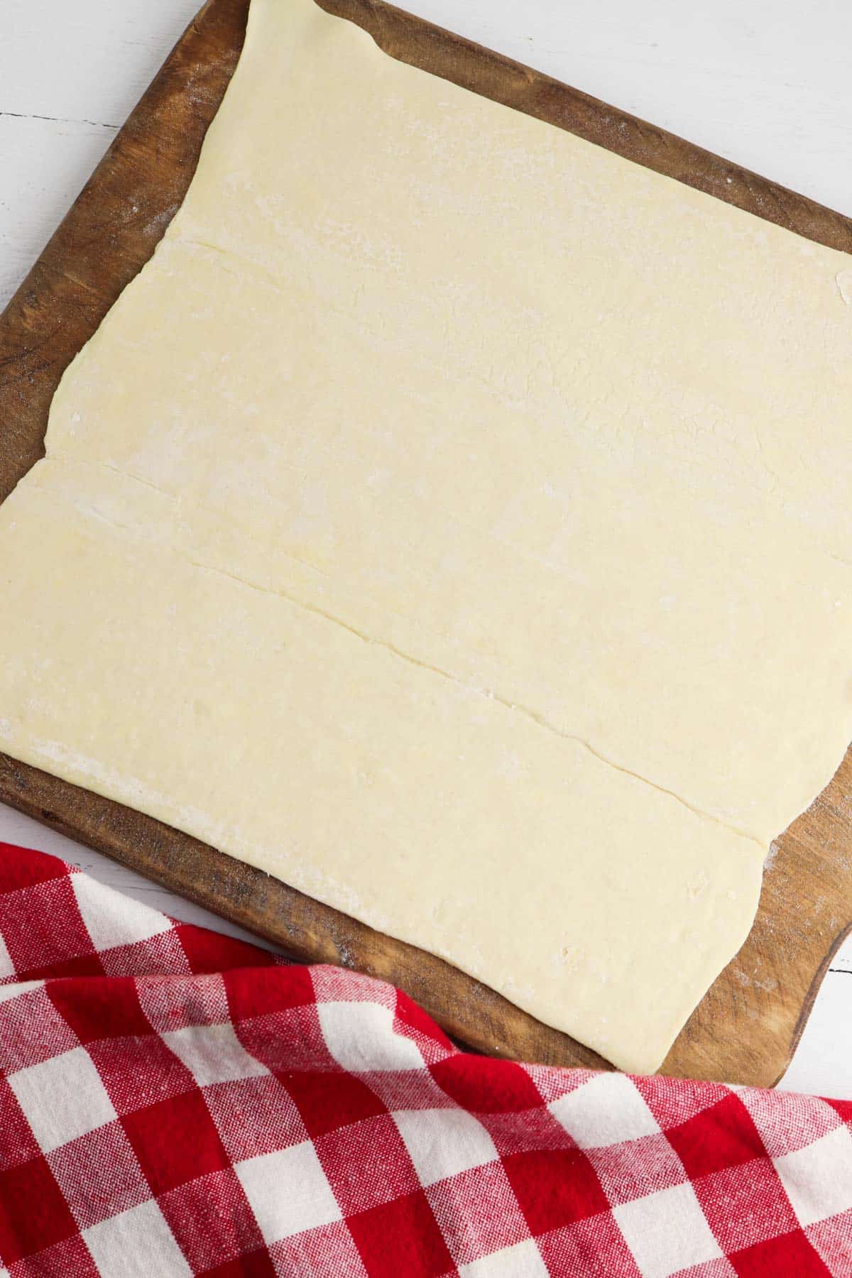 A sheet of pastry dough on a cutting board.