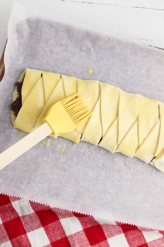 A pastry with a yellow spatula on top of it.