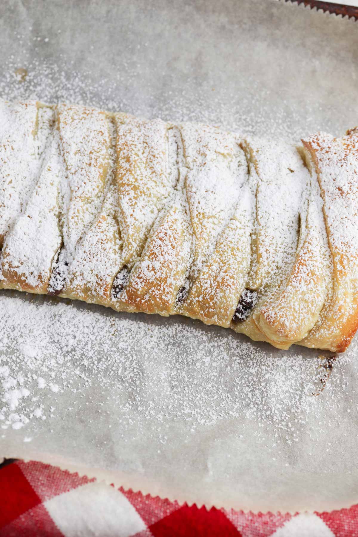 A pastry with powdered sugar on top.