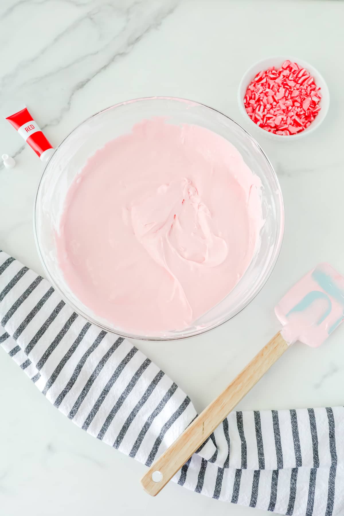 Next step in making Peppermint Fluff is to add drops of red coloring to the mixture.