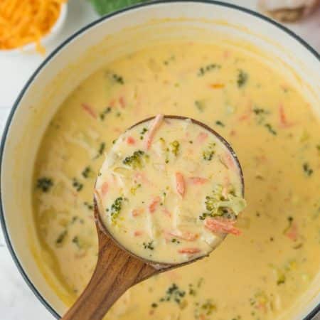 A bowl of soup with broccoli and carrots, perfect to serve with broccoli cheese soup.