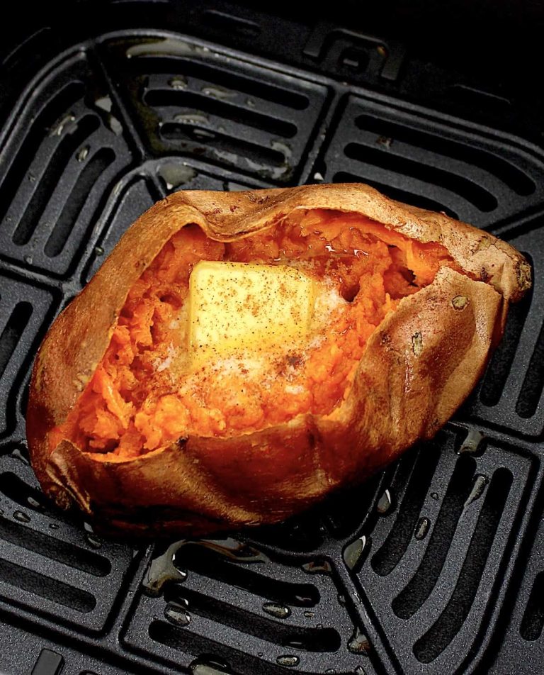A roasted sweet potato sitting in an air fryer.