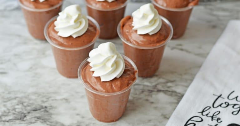 Chocolate mousse cups topped with whipped cream.