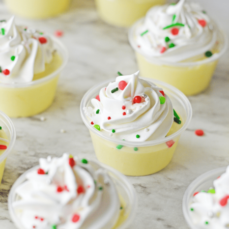 Lemon pudding cups with sprinkles and whipped cream.