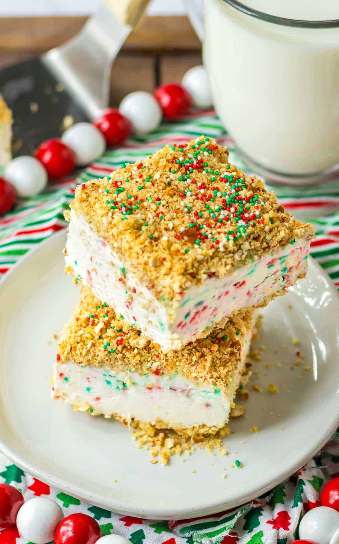 A stack of christmas ice cream crunch cake on a plate.
