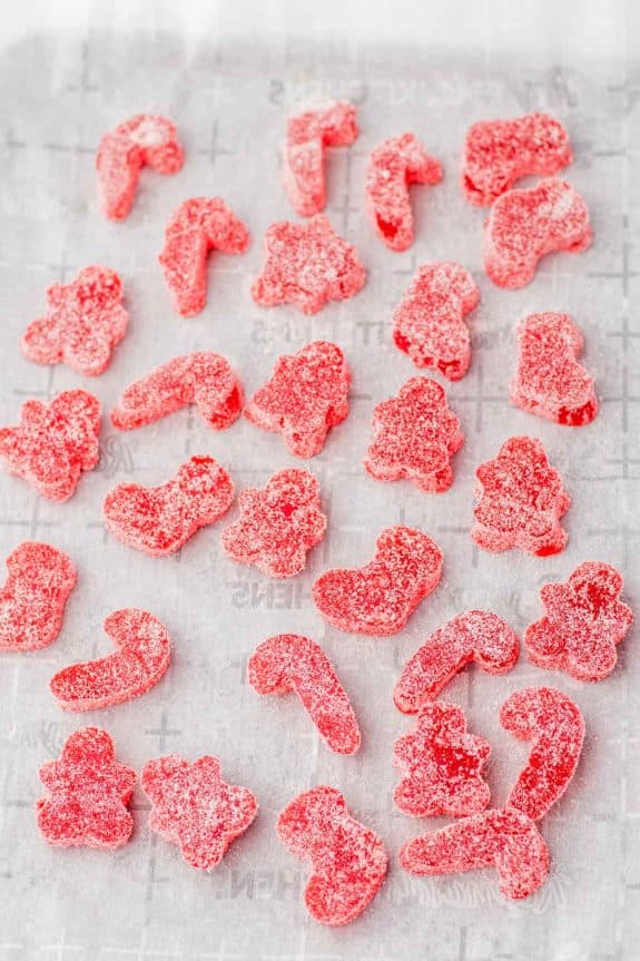 Red gummy bears on a baking sheet.