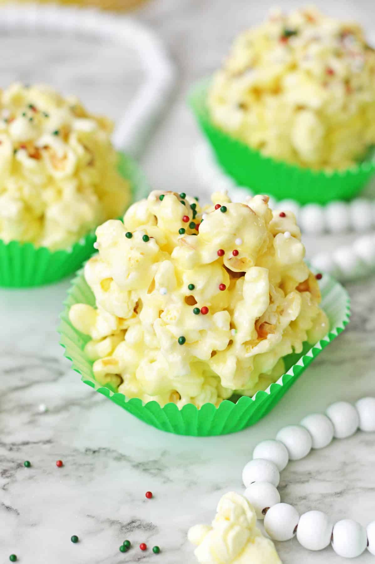 A group of popcorn balls in green cupcake liners