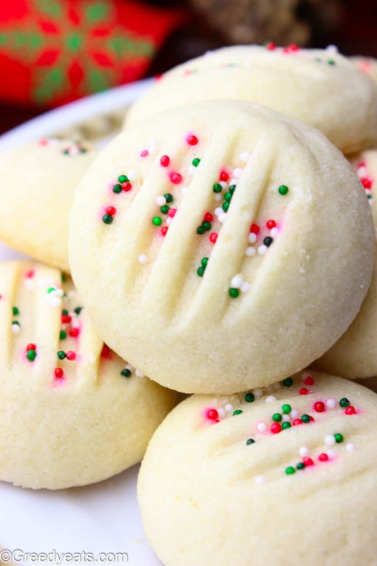 Sugar cookies with sprinkles on a plate.