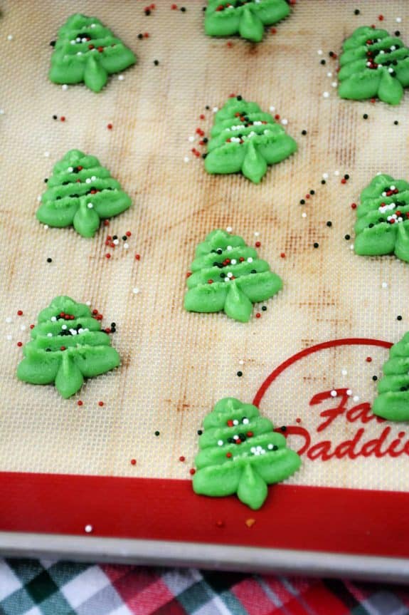 A baking sheet with green christmas trees on it.
