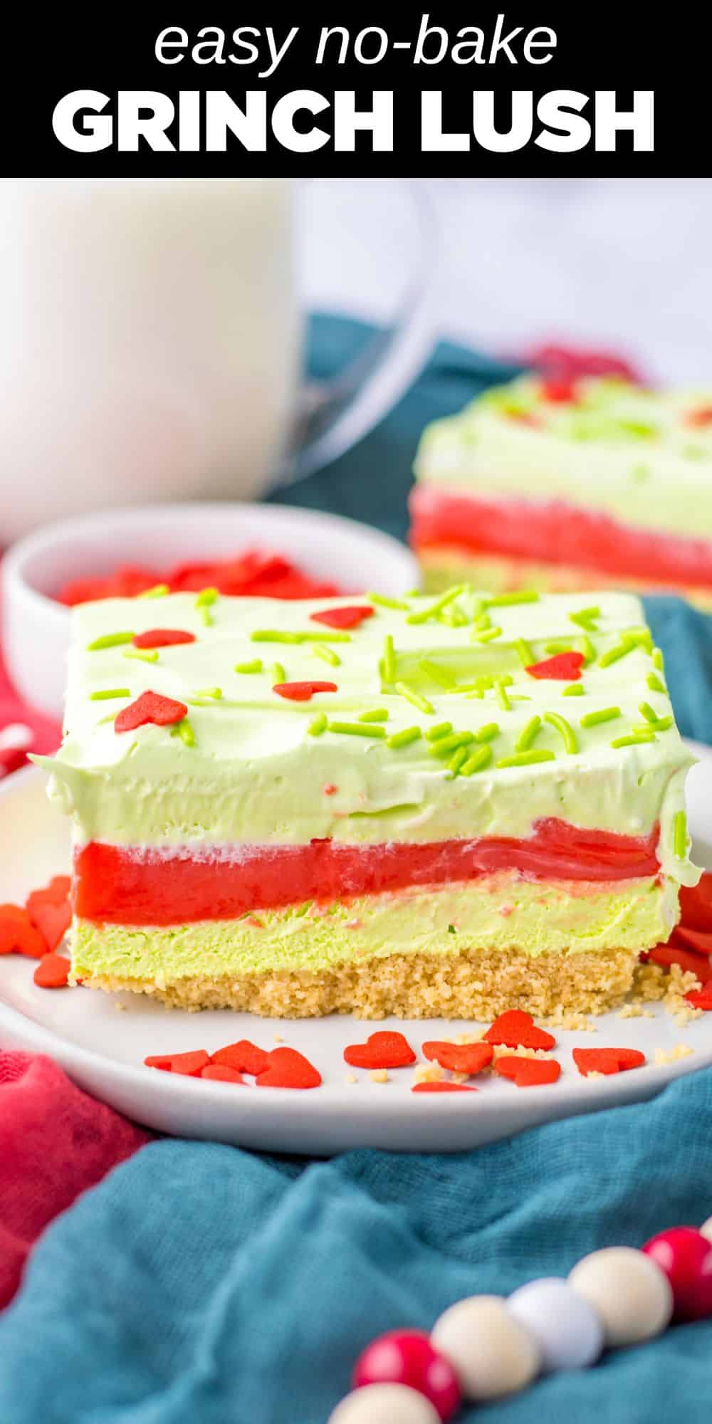 This sweet and creamy Grinch Layered Dessert is the perfect treat for the holiday season. Layers of vanilla cookies, fluffy cheesecake, and a creamy peppermint pudding layer get topped with whipped cream and sprinkles for a fun Grinch theme.