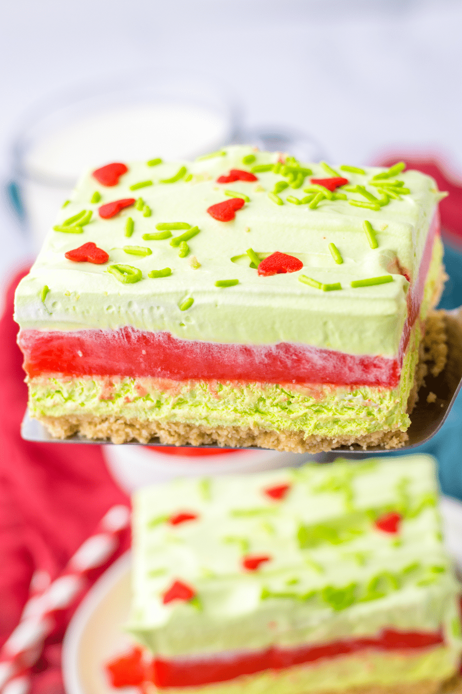 A slice of Grinch layered dessert on a plate.