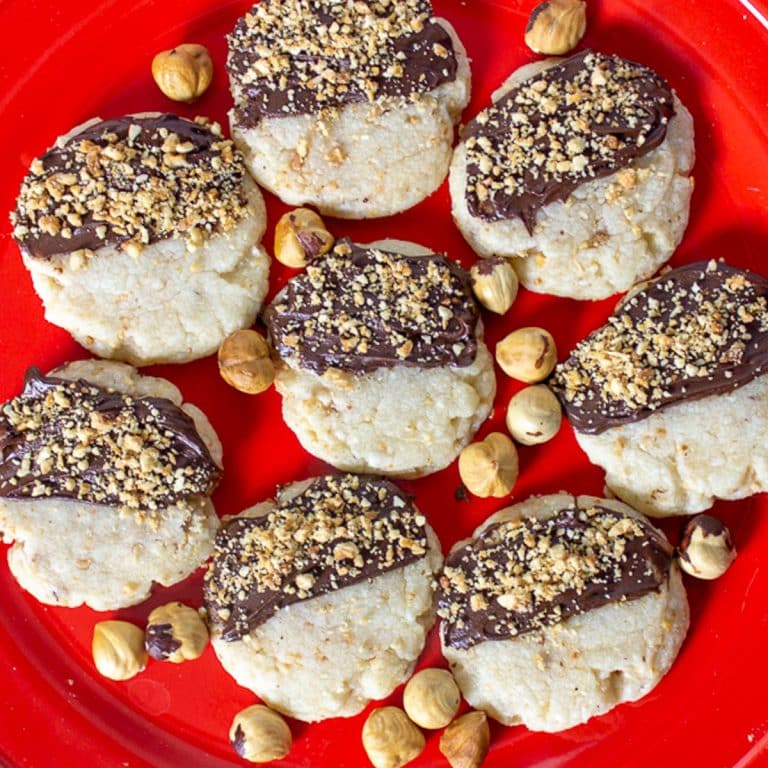 Chocolate hazelnut cookies on a red plate.