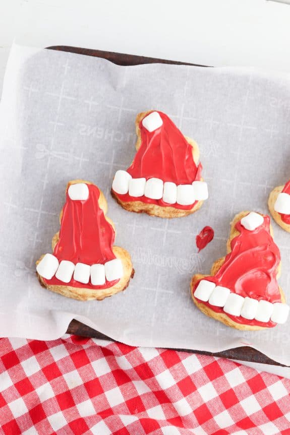 Santa hat cookies on a baking sheet.