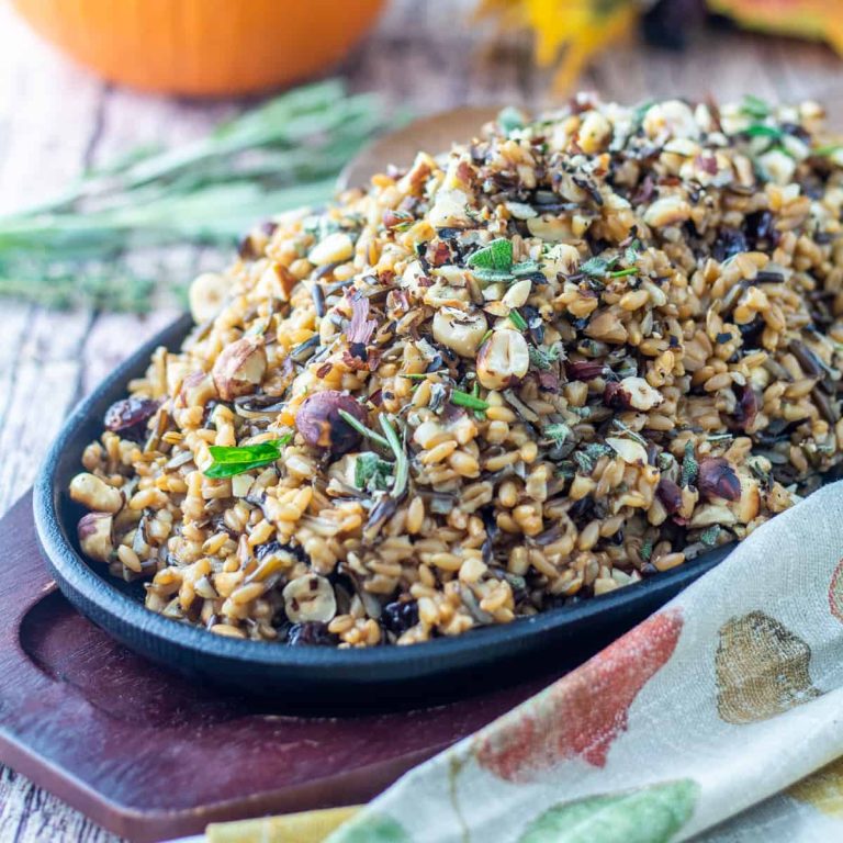 A bowl of wild rice with cranberries and nuts.