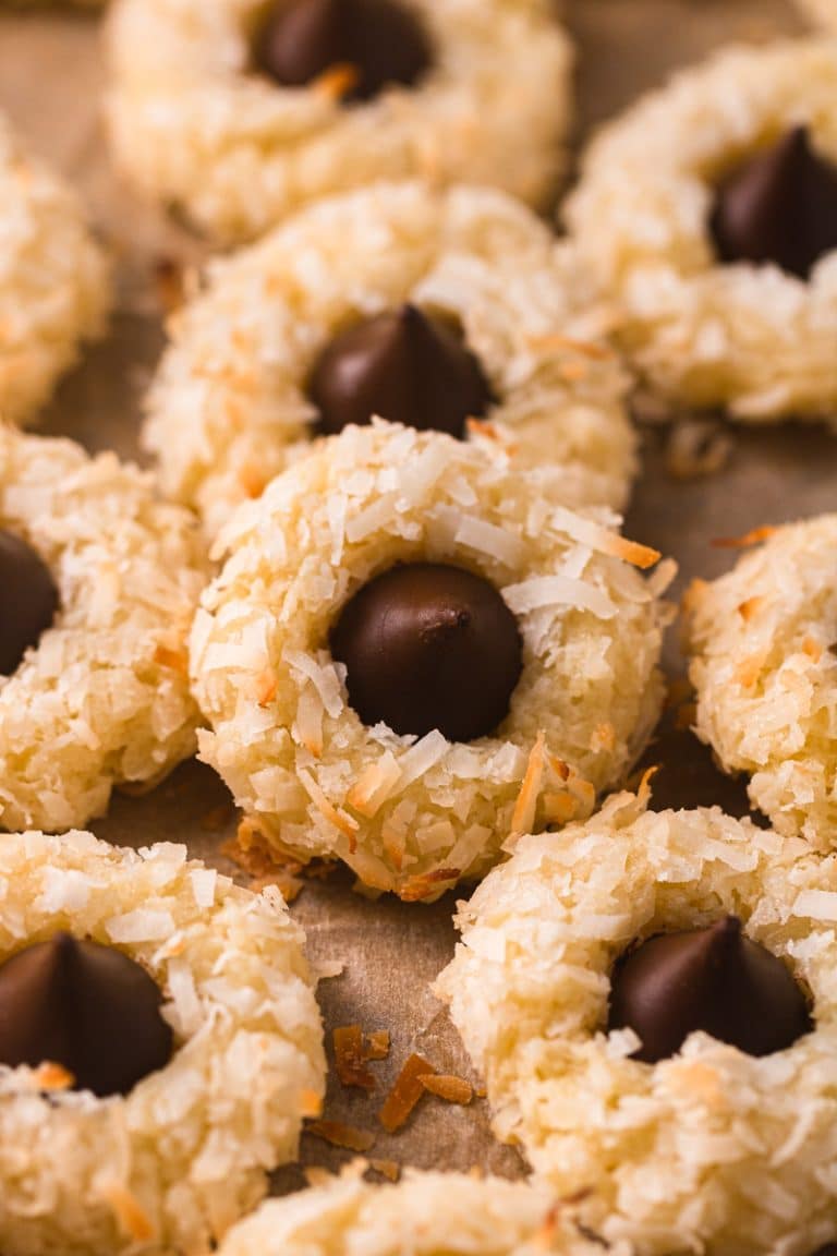 Coconut macaroons with chocolate chips on a baking sheet.