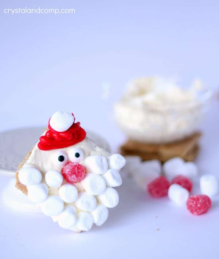 Santa claus graham crackers with marshmallows and candy canes.