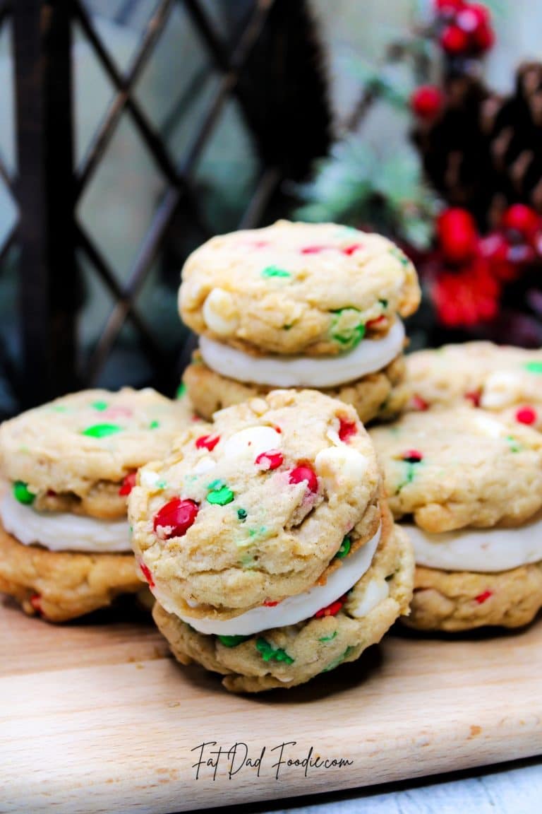 A stack of christmas cookies on a cutting board.