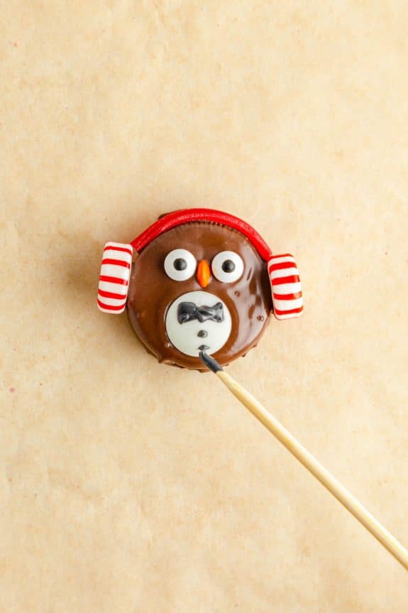 An Oreo penguin with a red and white striped hat.