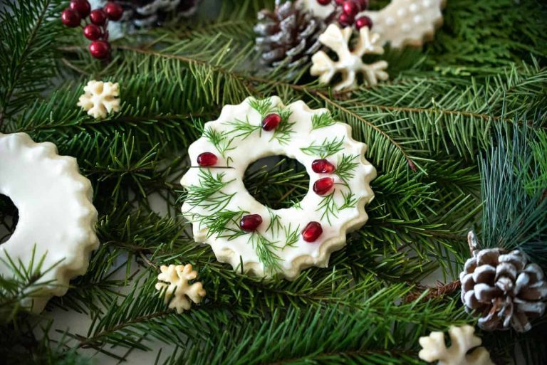 A christmas wreath decorated with icing and pine cones.
