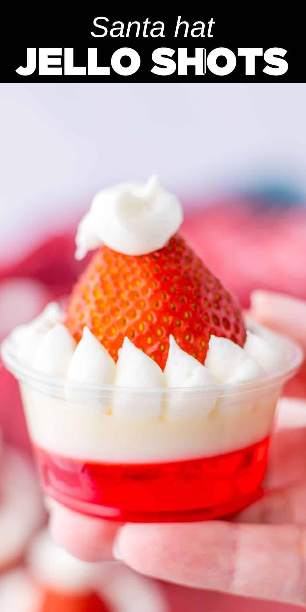 These Santa Hat Jello Shots are a festive addition to any Christmas holiday party. Layers of red and white Jello with buttercream and strawberry topping look just like Santa's hat!  You can even make a nonalcoholic version for the kids.