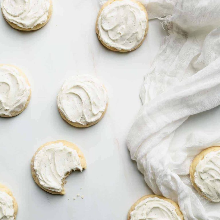 White icing cookies with a bite taken out of them.
