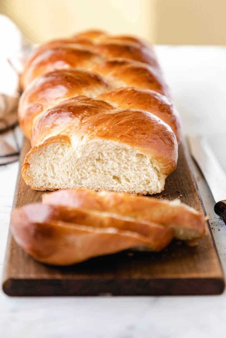 A loaf of braided bread on a cutting board.