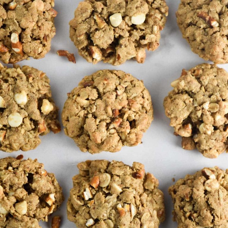 Oatmeal cookies with pecans and walnuts on a baking sheet.